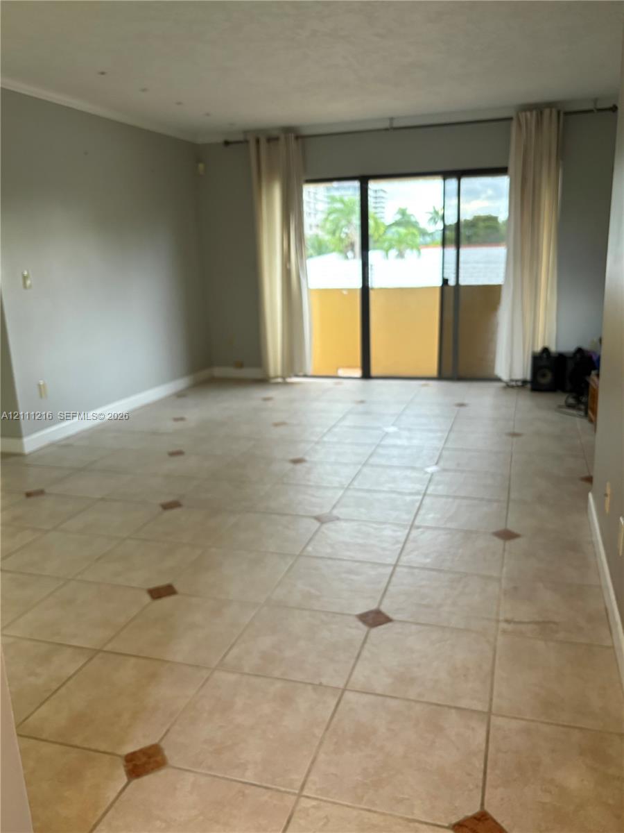 Interior space featuring tile flooring with decorative stone accents and sliding glass doors providing external access