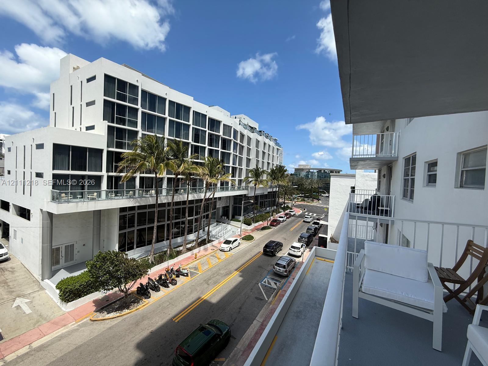 Elevated outdoor balcony with metal railings and concrete flooring Elevated outdoor balcony with metal railings and concrete flooring