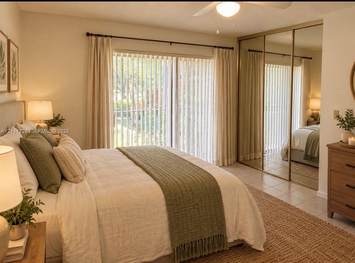 Sliding glass door with vertical blinds, ceiling fan, and triple-panel mirrored closet doors