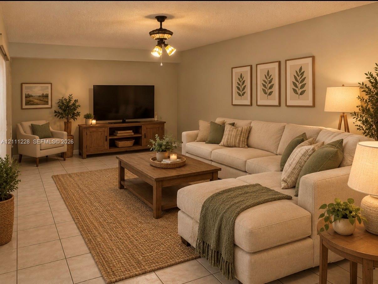 Living area featuring neutral-toned tile flooring and a ceiling-mounted light fixture with three glass shades