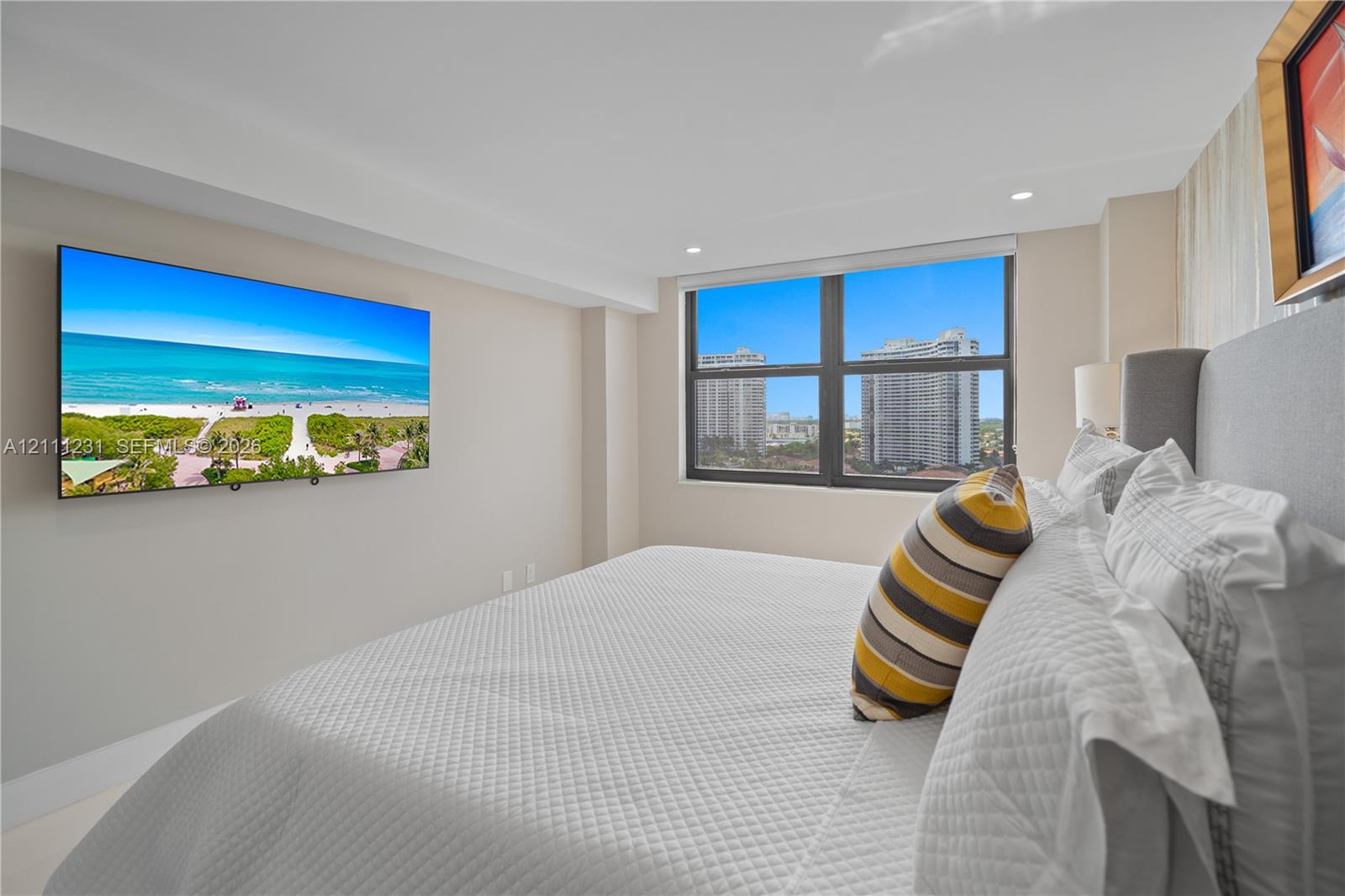 Large window with dark-toned frame and recessed ceiling lighting