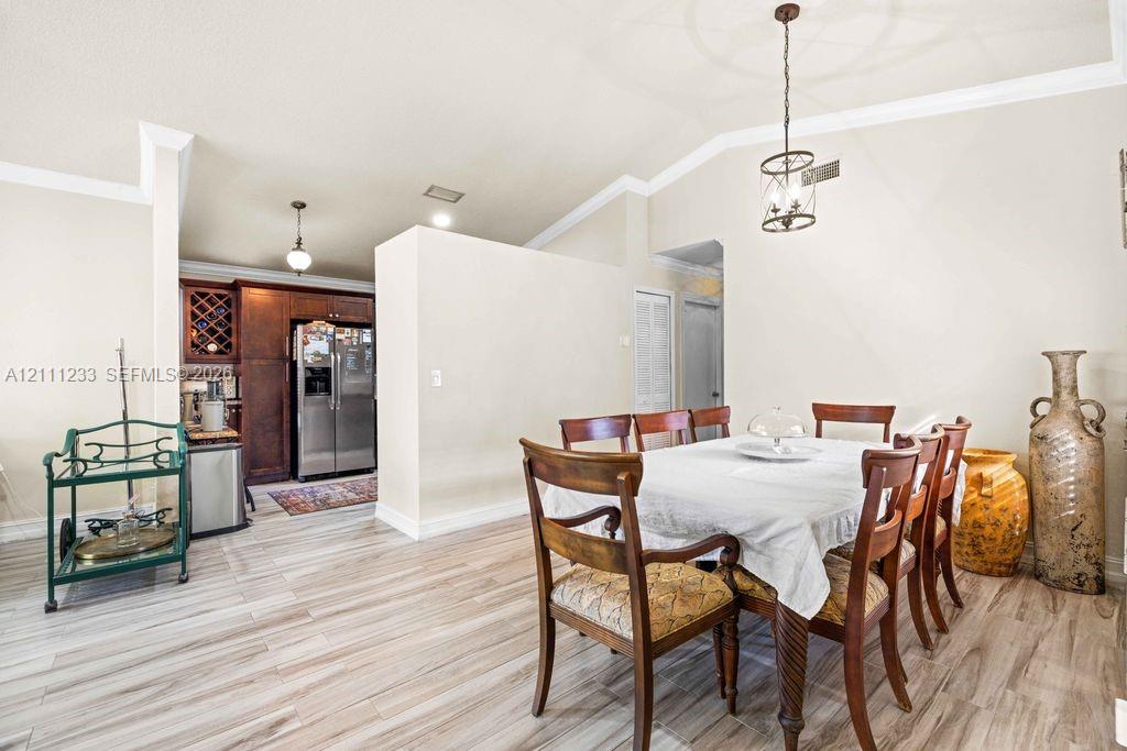 Vaulted ceilings, wood-finish flooring, custom built-in wine storage, and decorative pendant lighting Vaulted ceilings, wood-finish flooring, custom built-in wine storage, and decorative pendant lighting