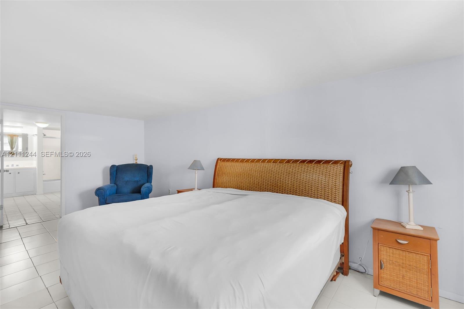 Spacious room featuring neutral wall tones and large-format tile flooring