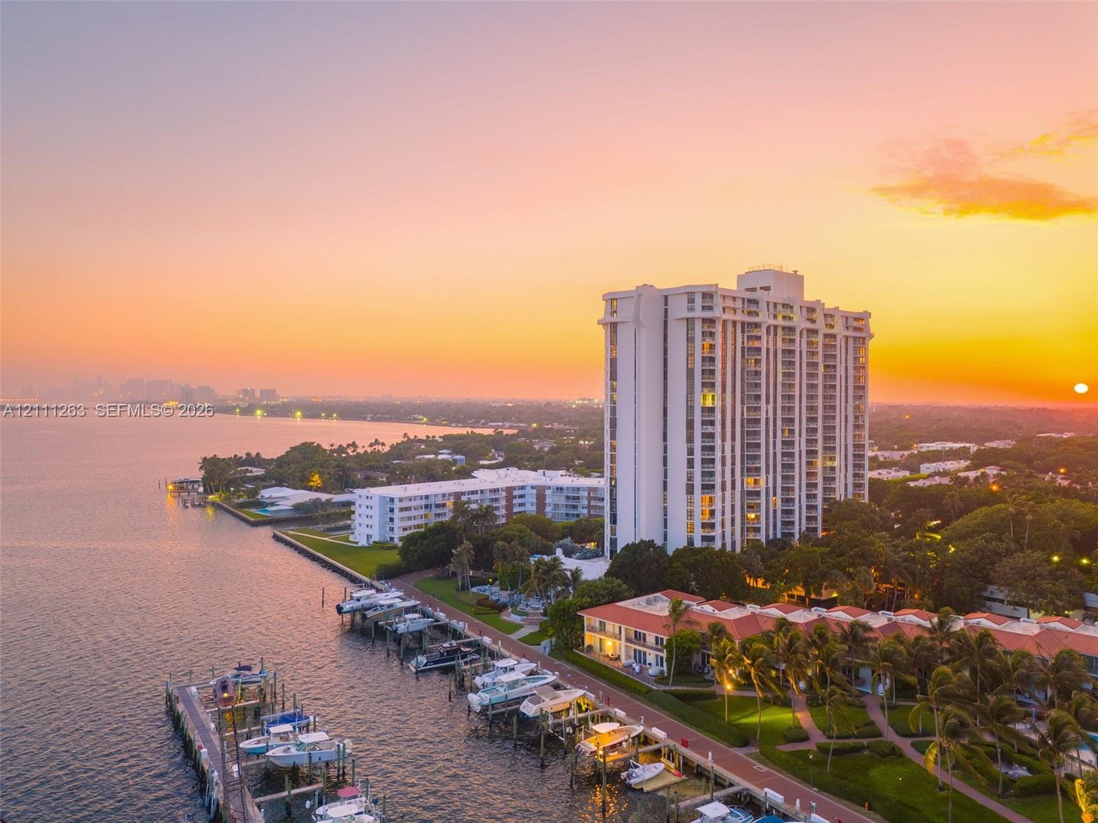 Waterfront high-rise building featuring private boat slips, extensive landscaped grounds, and paved walking paths