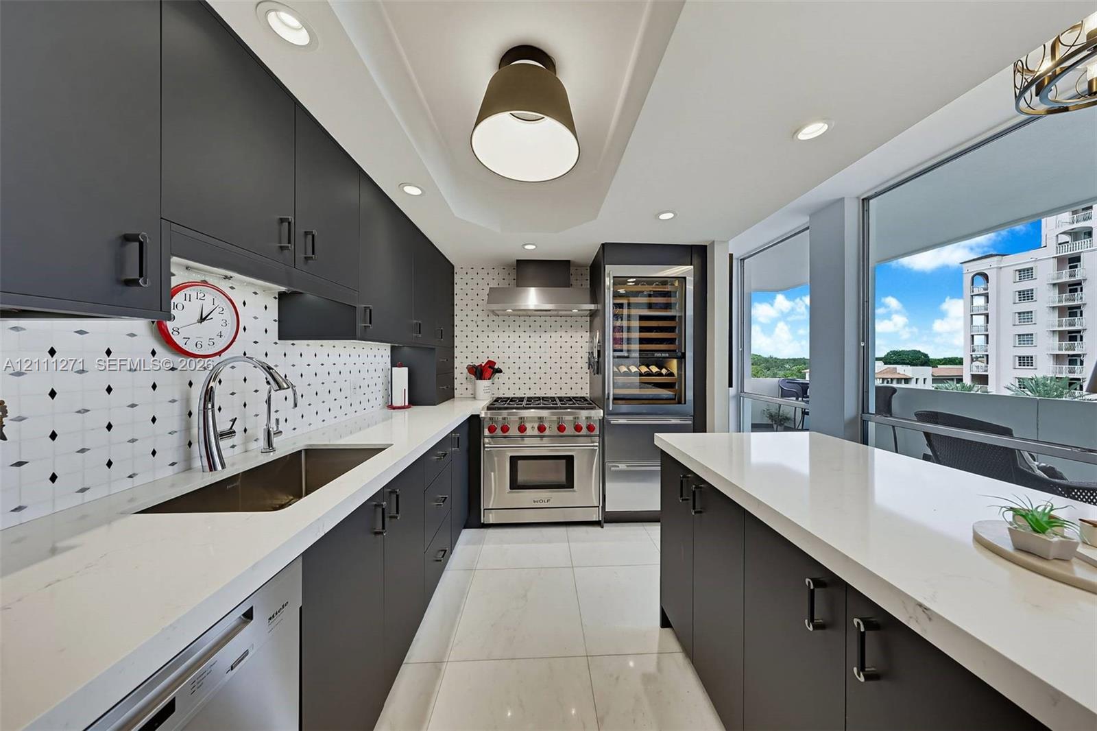 Kitchen featuring matte-finish cabinetry, quartz countertops, geometric patterned tile backsplash, stainless steel gas range, and built-in wine refrigeration Kitchen featuring matte-finish cabinetry, quartz countertops, geometric patterned tile backsplash, stainless steel gas range, and built-in wine refrigeration