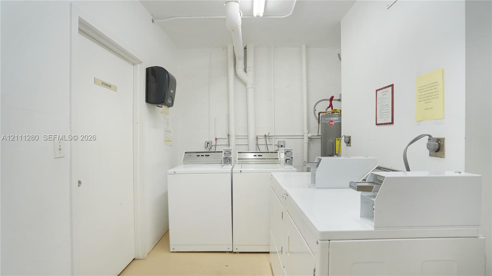 Laundry area featuring white appliances, a built-in folding counter, and a dedicated storage closet