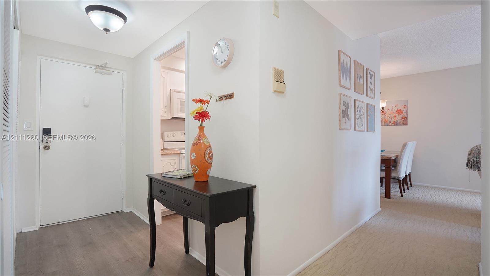 Entryway featuring wood-finish flooring, a neutral color palette, and a flush-mount ceiling light fixture