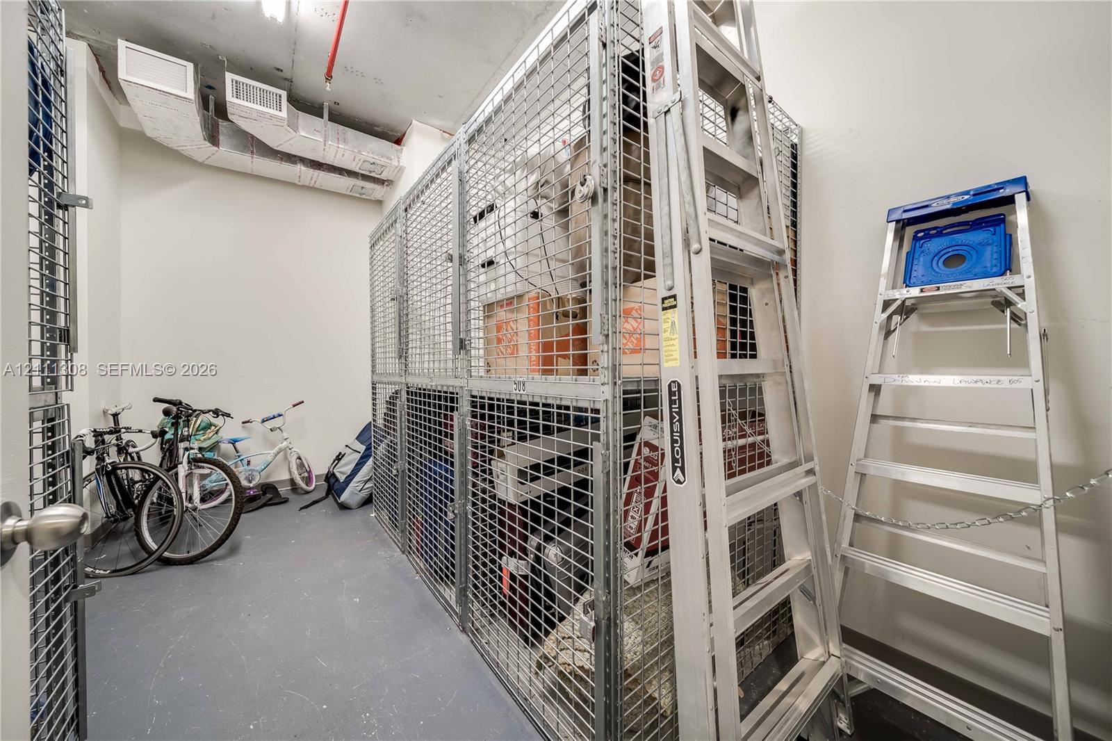 Dedicated storage unit featuring floor-to-ceiling metal mesh partitioning and durable concrete flooring
