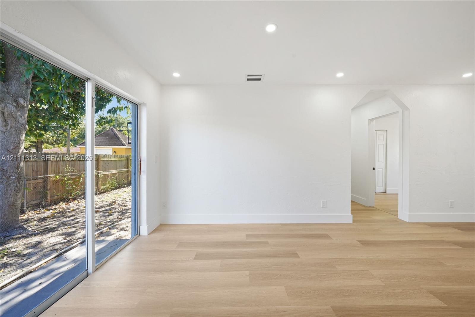 Interior space featuring wood-finish flooring, recessed lighting, and a large sliding glass door