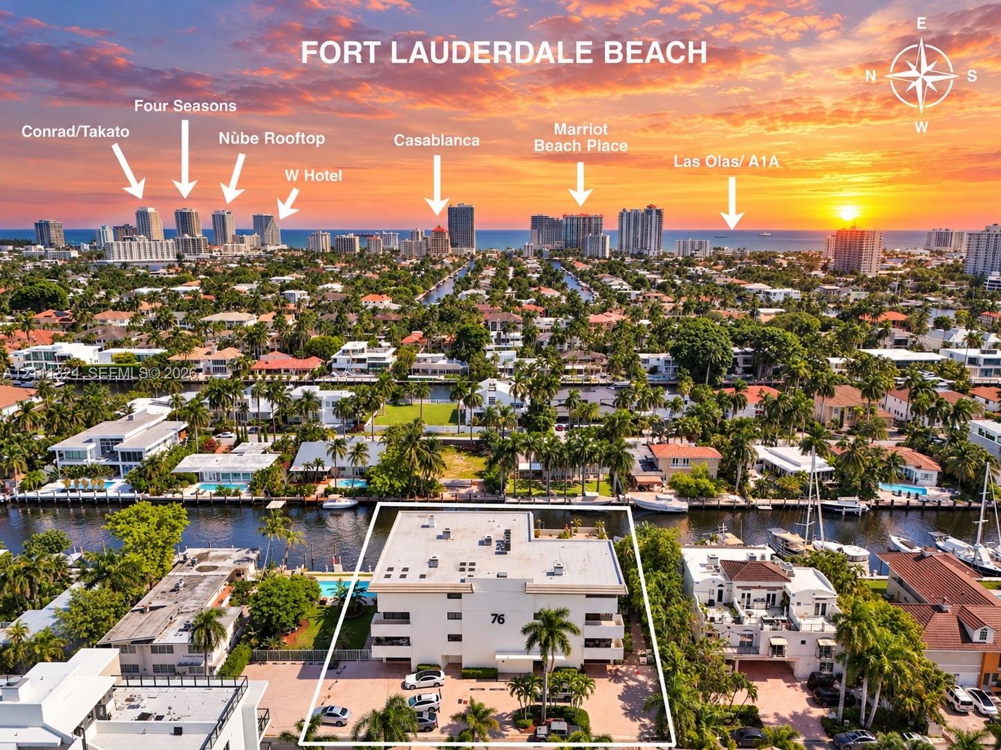 Aerial perspective of property featuring deep-water canal frontage, paved surface parking, and mature palm trees Aerial perspective of property featuring deep-water canal frontage, paved surface parking, and mature palm trees
