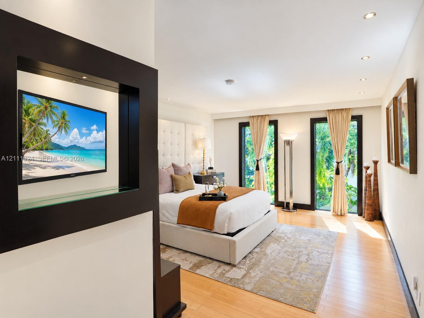Wood-finish flooring, recessed ceiling lighting, and dual glass-paneled exterior doors with dark-toned frames