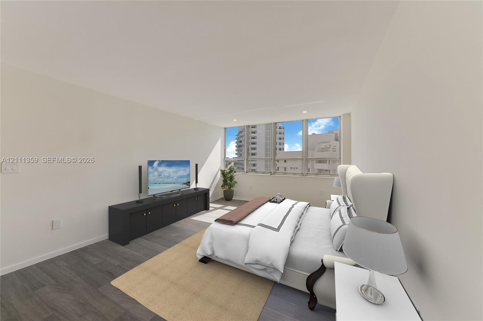 Neutral-toned room featuring expansive floor-to-ceiling windows and wood-finish flooring