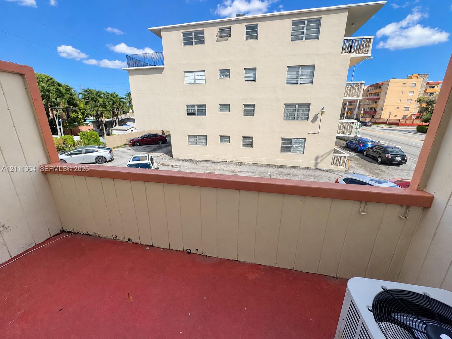 Private balcony featuring painted concrete flooring, vertical siding, and a solid railing