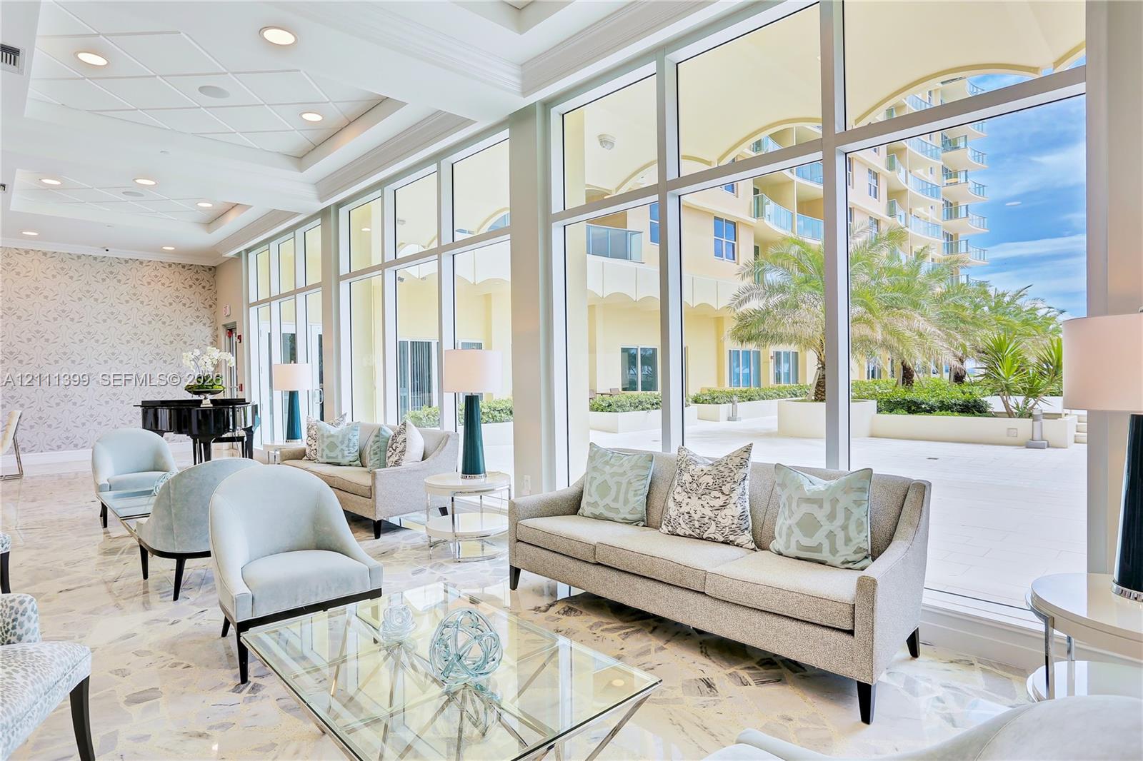 Floor-to-ceiling windows, recessed lighting, coffered ceiling, and stone flooring