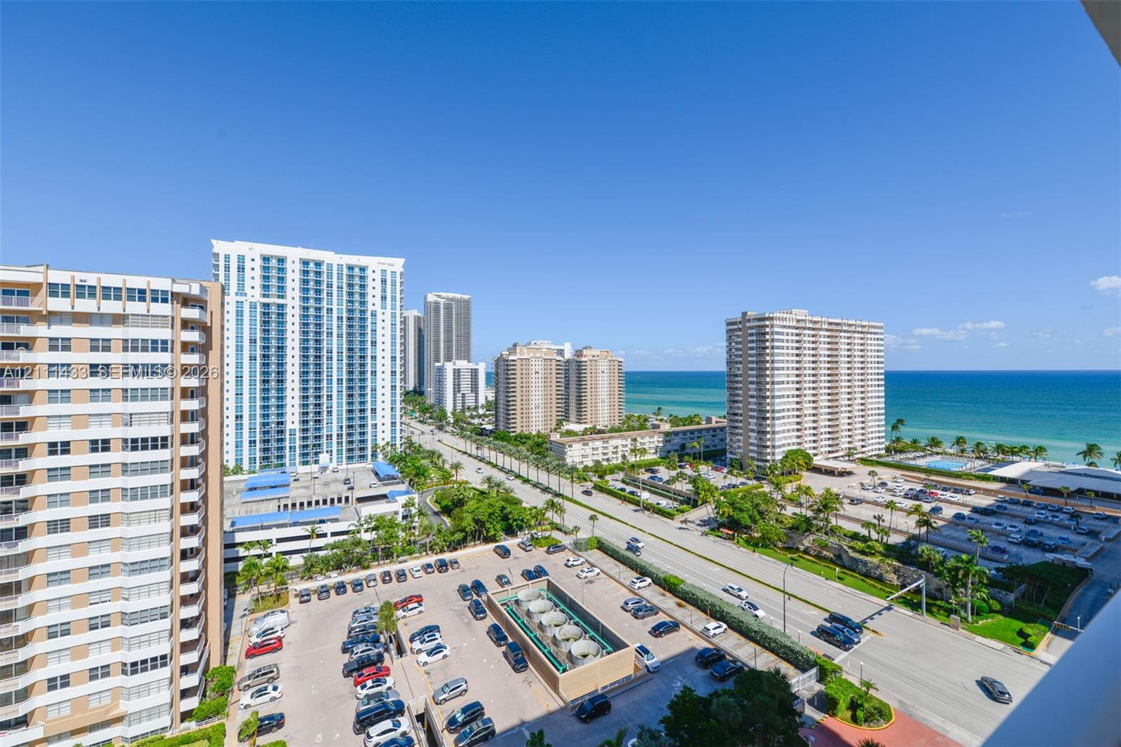 Elevated coastal panorama featuring high-rise architecture, urban thoroughfare, and direct ocean water frontage