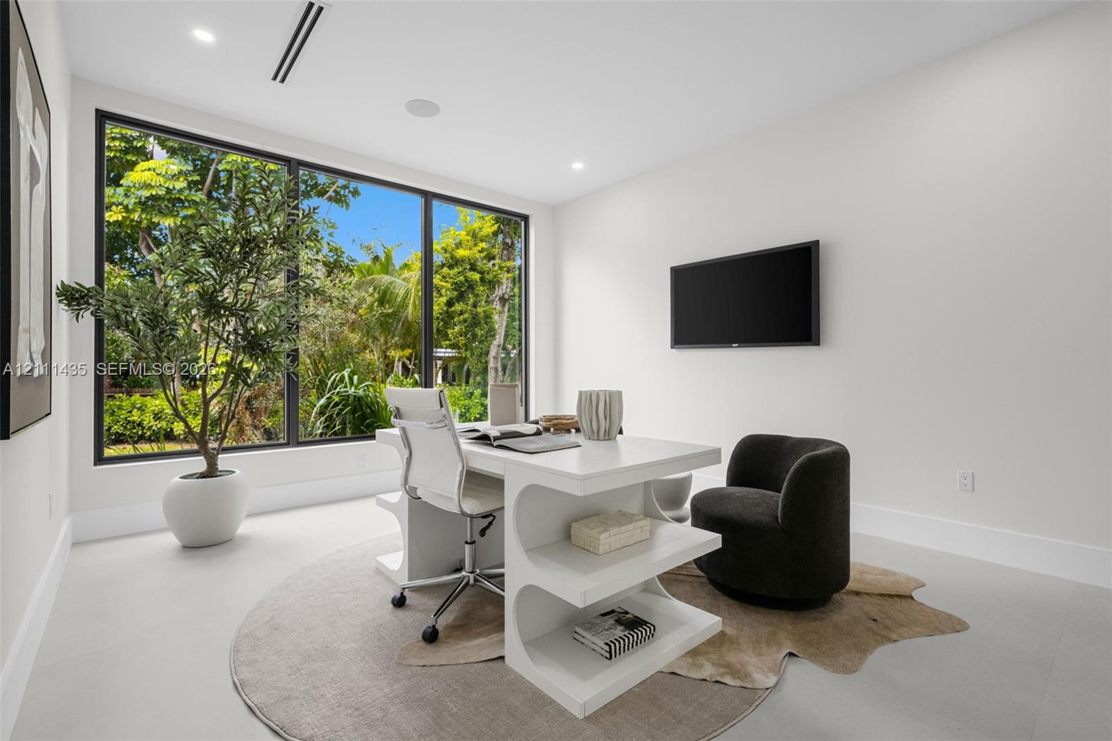 Large format floor-to-ceiling window with black trim, recessed lighting, and smooth-finish flooring