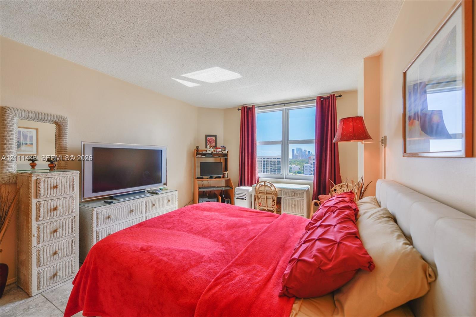 Room with multi-pane window, neutral wall paint, and tile flooring