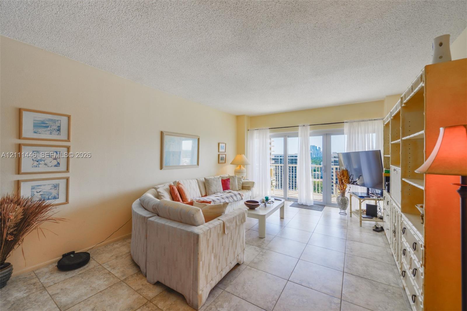 Large format floor tiling, expansive glass sliding doors, and built-in floor-to-ceiling cabinetry