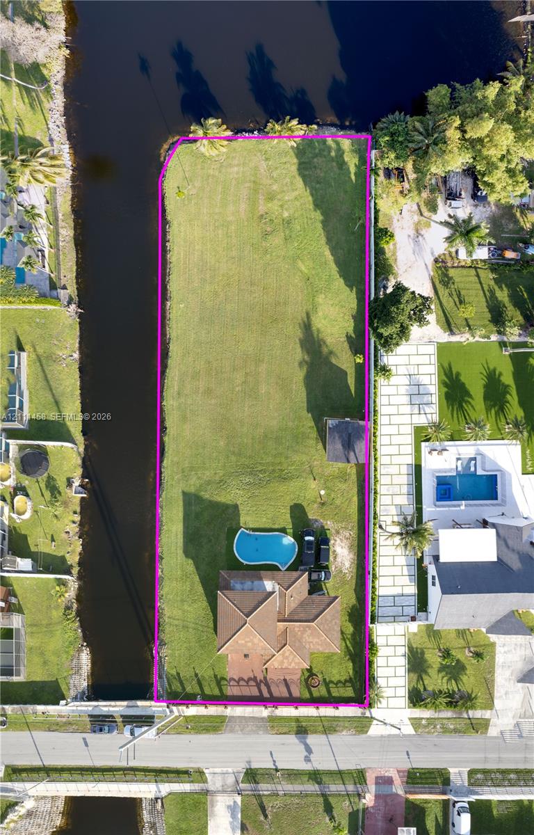 Waterfront lot featuring a private swimming pool, expansive lawn
