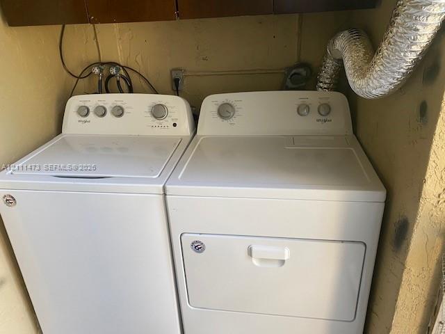 Laundry area equipped with a top-loading washer and front-loading dryer