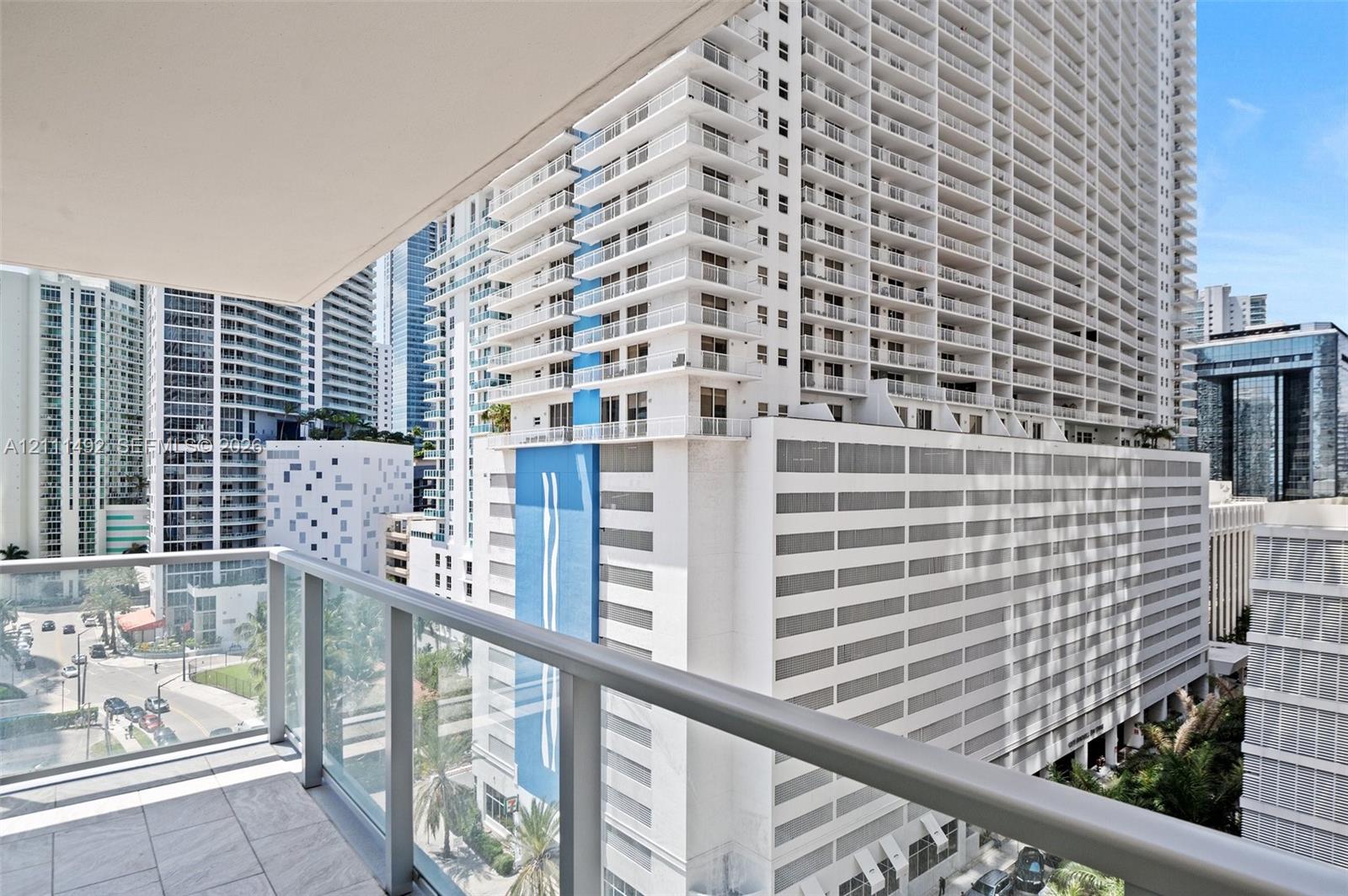 Private balcony featuring glass panel railings and tile flooring