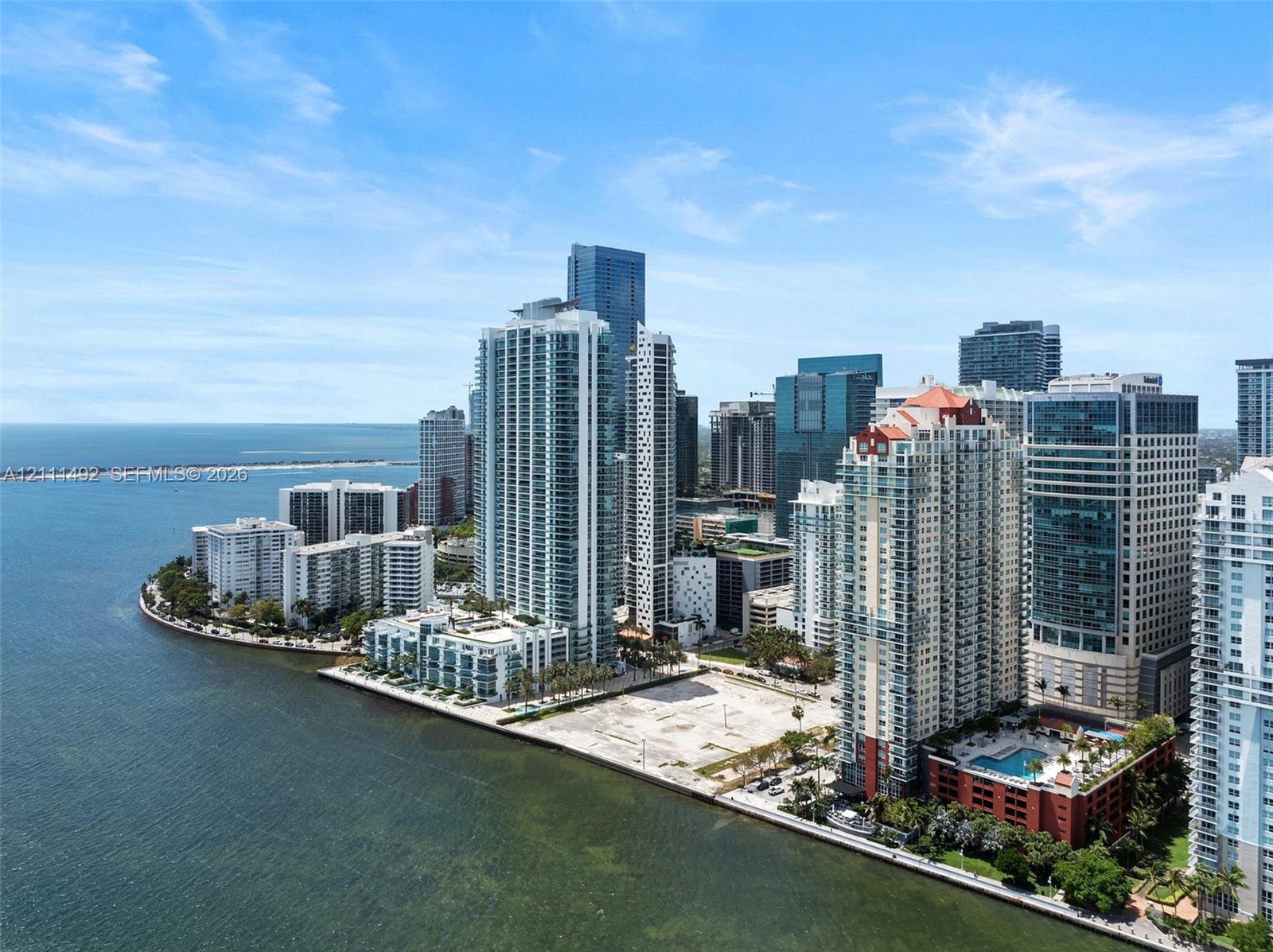 Aerial perspective of a high-rise residential district featuring extensive waterfront access, coastal panoramas, and dense urban infrastructure
