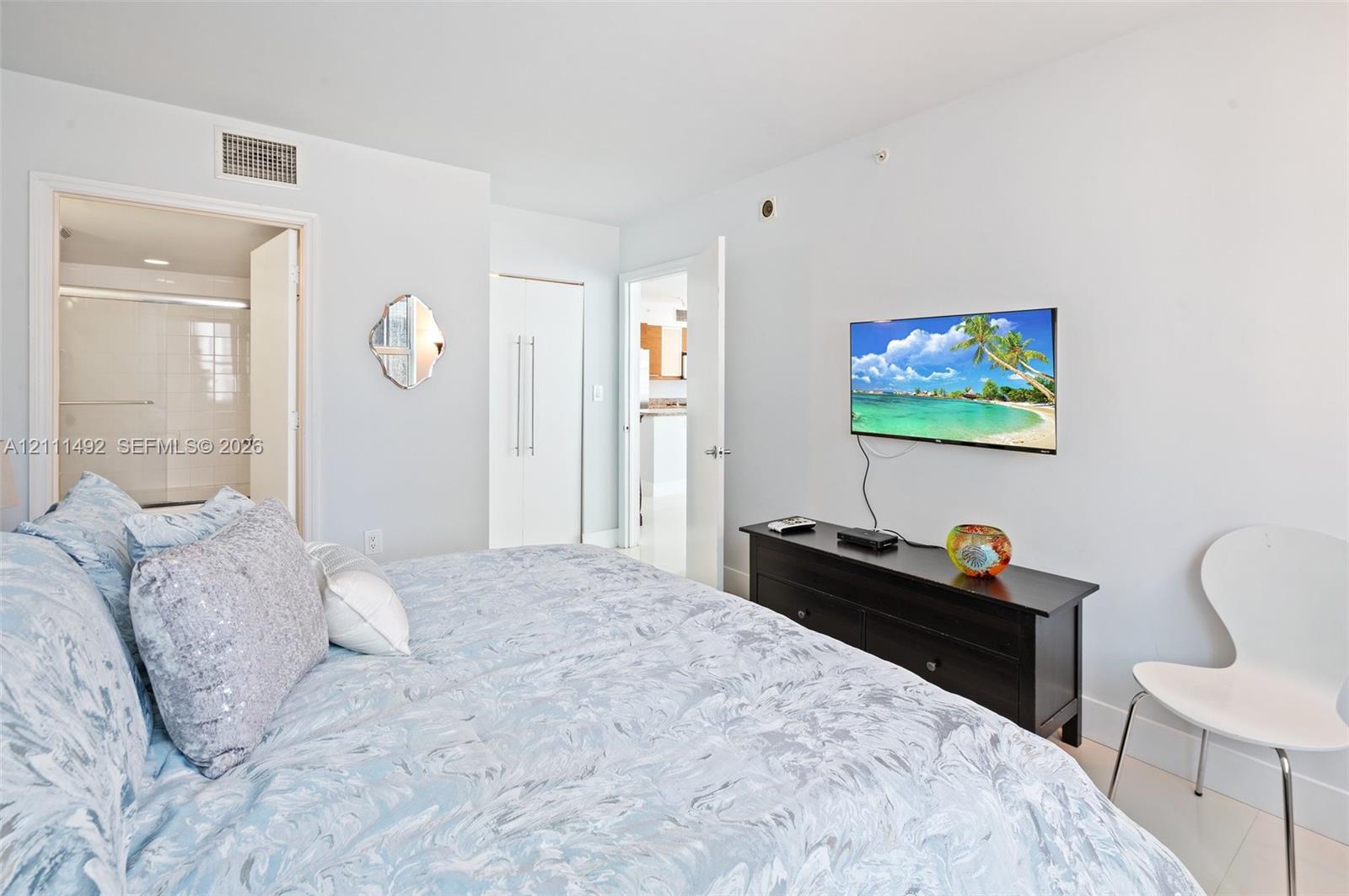 Neutral interior with gloss-finish tile flooring and high-reaching doors