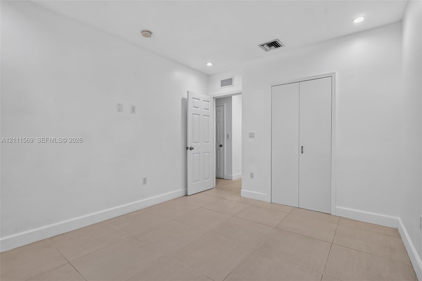 Interior space featuring large-format ceramic tile flooring, recessed lighting, and a closet with double-panel doors