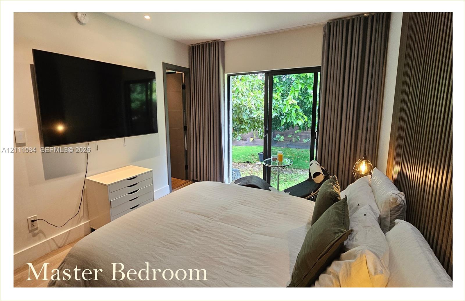Sliding glass doors, textured wall paneling, and wood-finish flooring