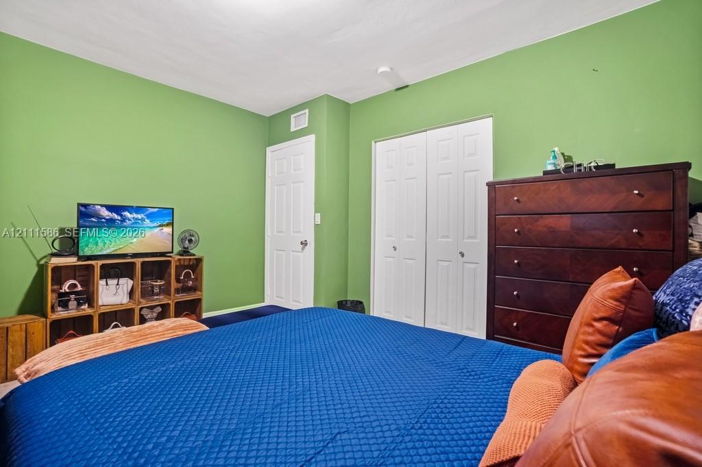 Interior space featuring white six-panel doors and a double-door reach-in closet