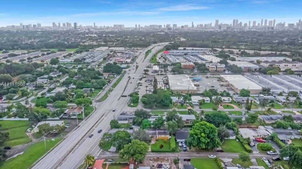 Aerial perspective showcasing urban skyline backdrops, mature tree canopy, and access to local thoroughfares