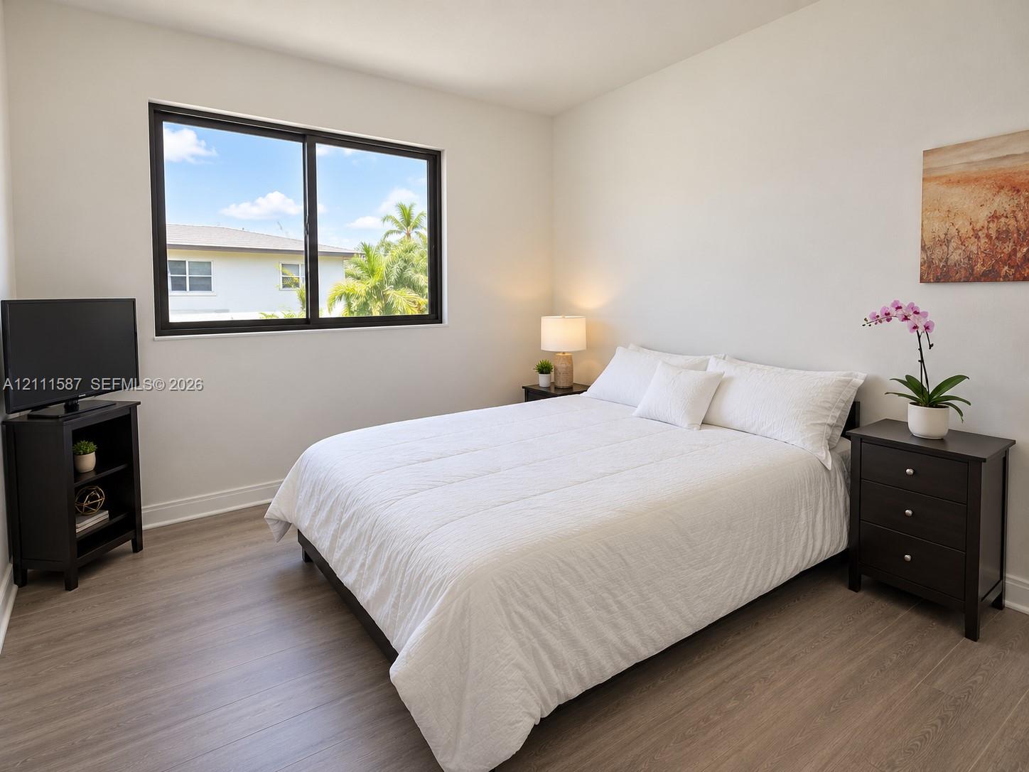 Wood-finish flooring and black-framed horizontal sliding window