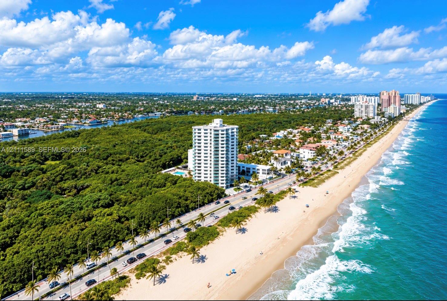 Aerial perspective featuring coastal proximity, high-rise residential structure, expansive oceanfront, and natural preserve Aerial perspective featuring coastal proximity, high-rise residential structure, expansive oceanfront, and natural preserve