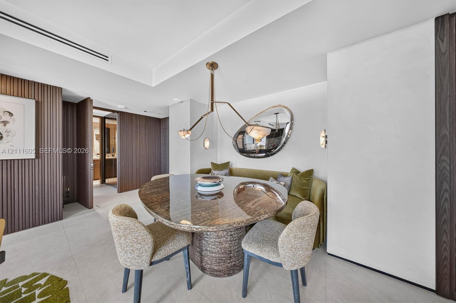 Custom vertical slat wood wall paneling, integrated tray ceiling, and minimalist recessed lighting