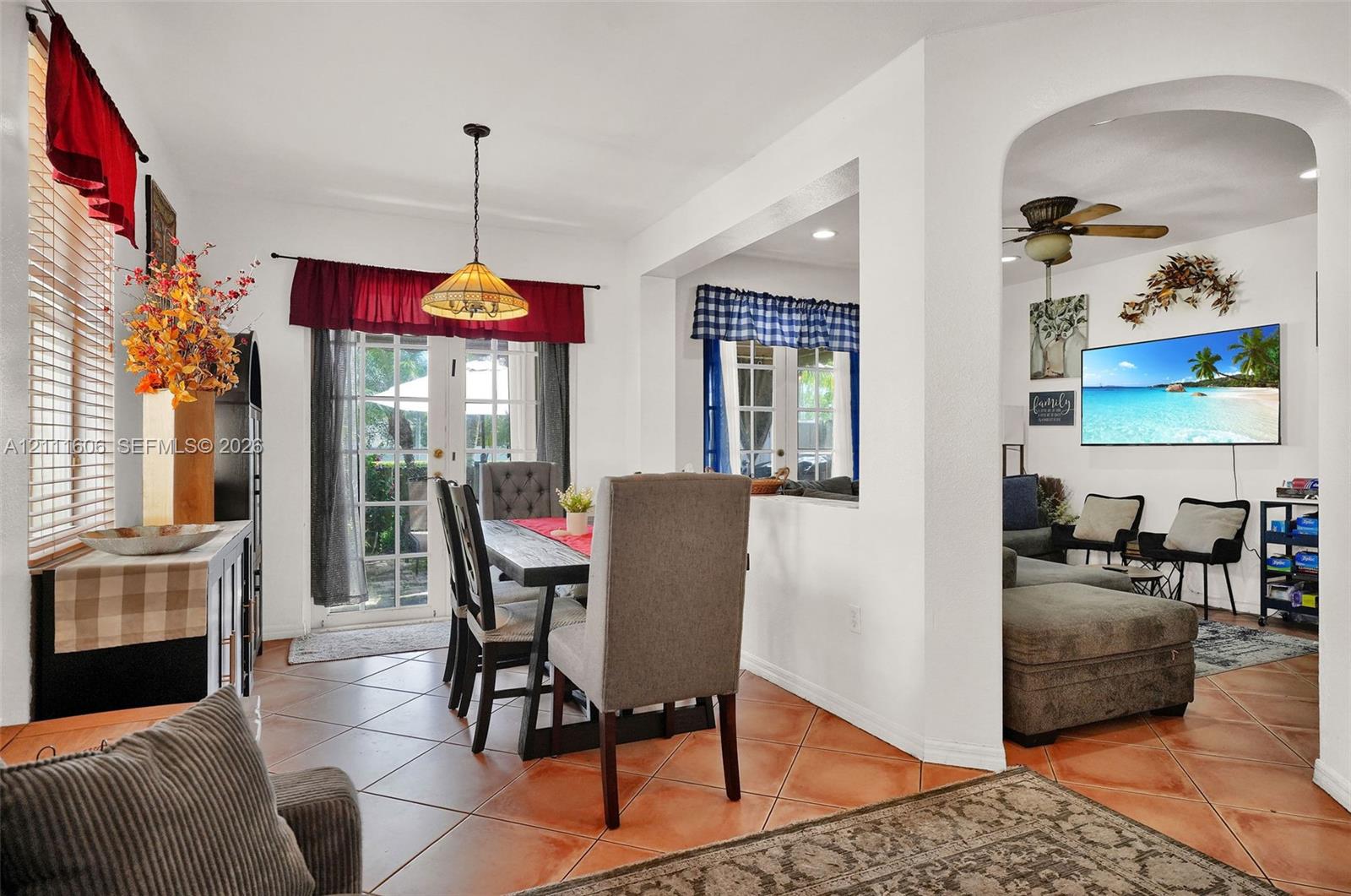 Ceramic tile flooring, arched wall opening, dual glass-paned doors, and pendant lighting Ceramic tile flooring, arched wall opening, dual glass-paned doors, and pendant lighting
