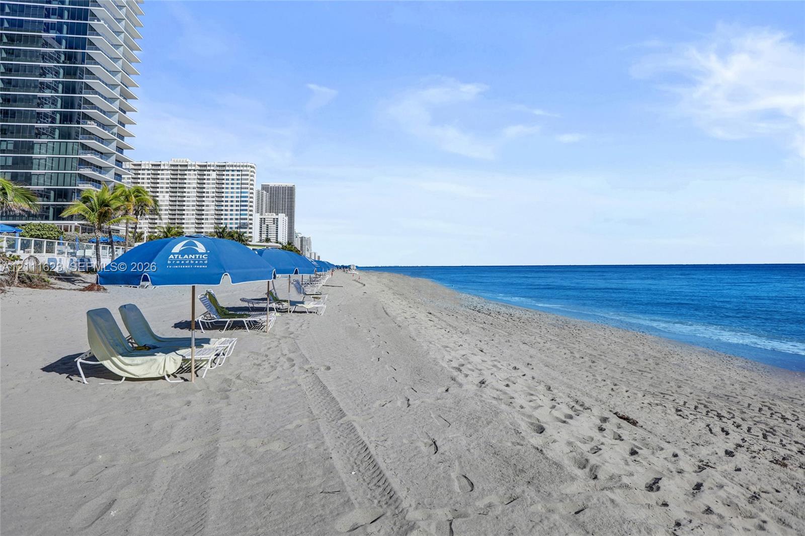 Sandy coastline featuring direct ocean frontage and immediate access to the beach