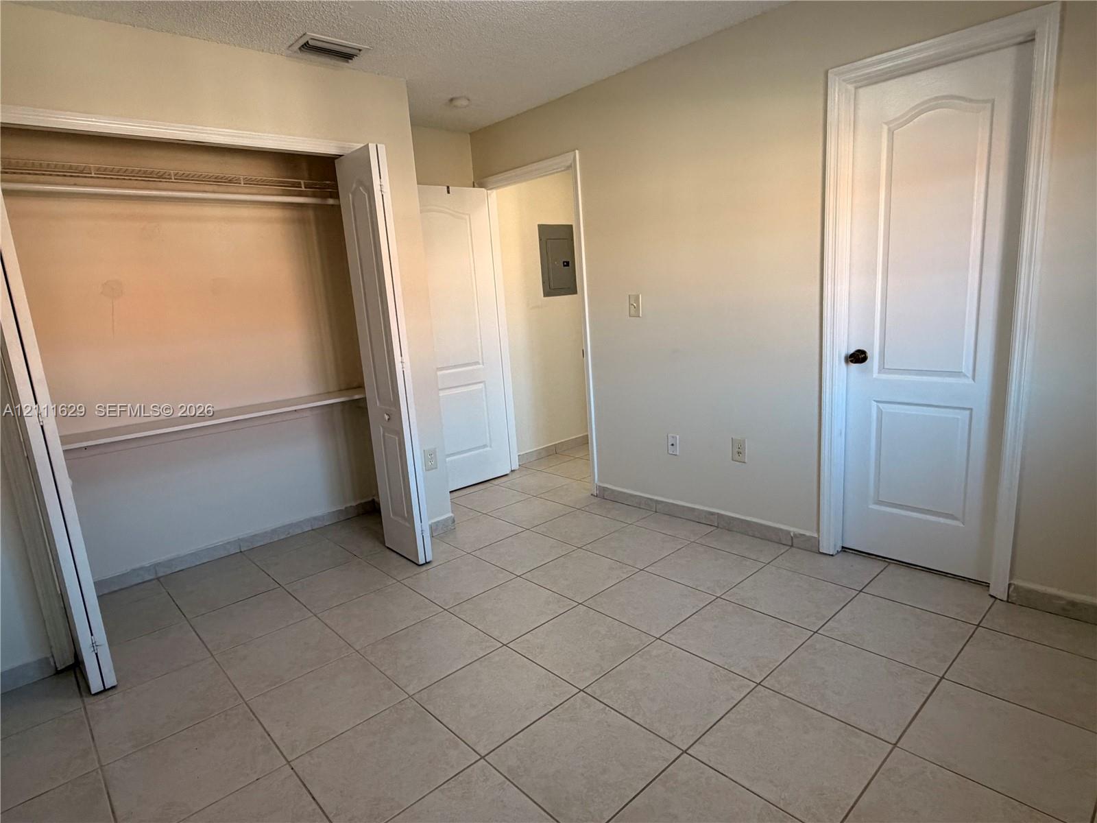 Ceramic tile flooring, paneled interior doors, and built-in closet shelving