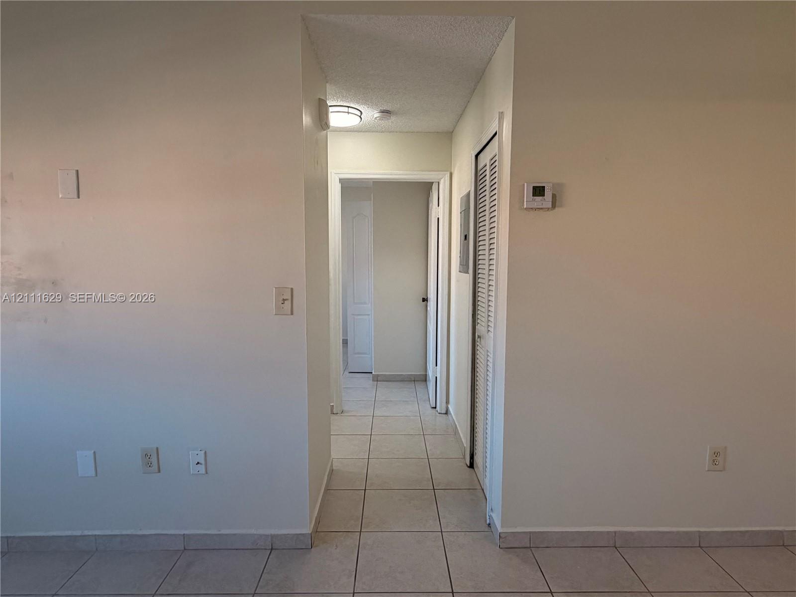 Ceramic tile flooring, louvered closet door, and recessed ceiling lighting
