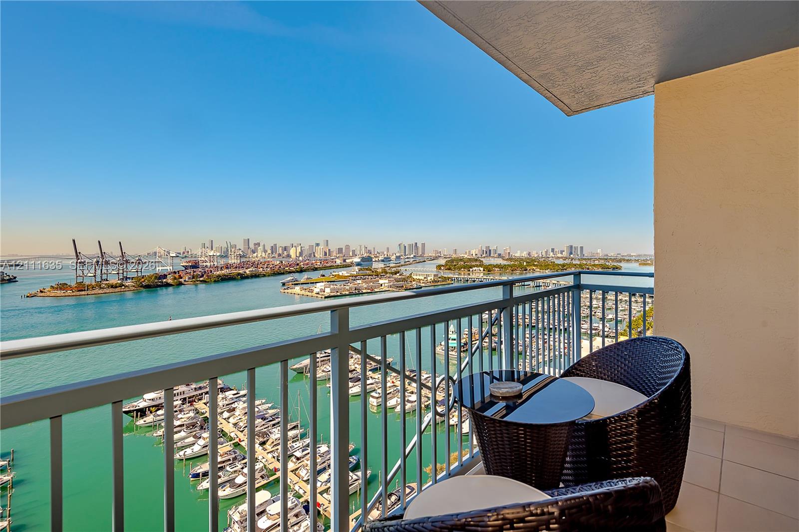 Private balcony with a metal railing, featuring large-format tile flooring and an overhead ceiling