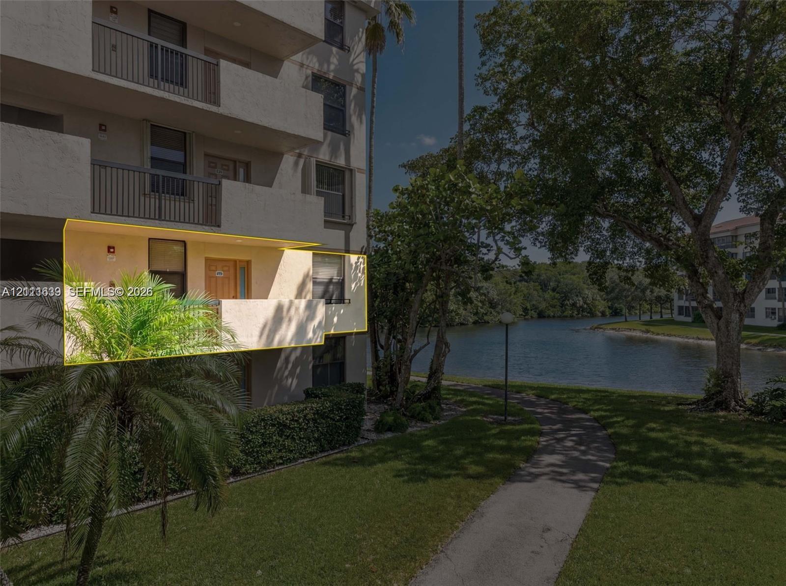 Private covered balcony featuring metal railings and direct access to exterior grounds