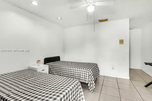 Room featuring recessed lighting, a white ceiling fan with integrated lighting, and neutral ceramic tile flooring