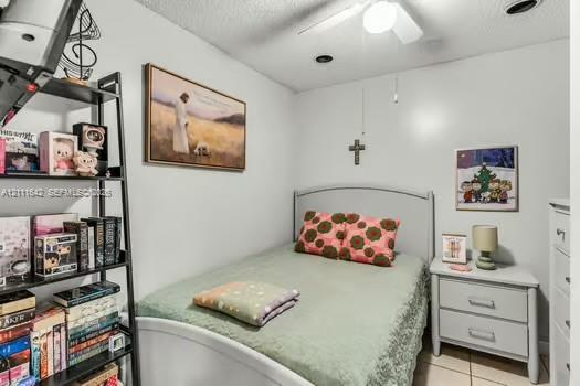 Neutral-toned interior room featuring tile flooring, recessed lighting, and a ceiling fan with integrated light fixture