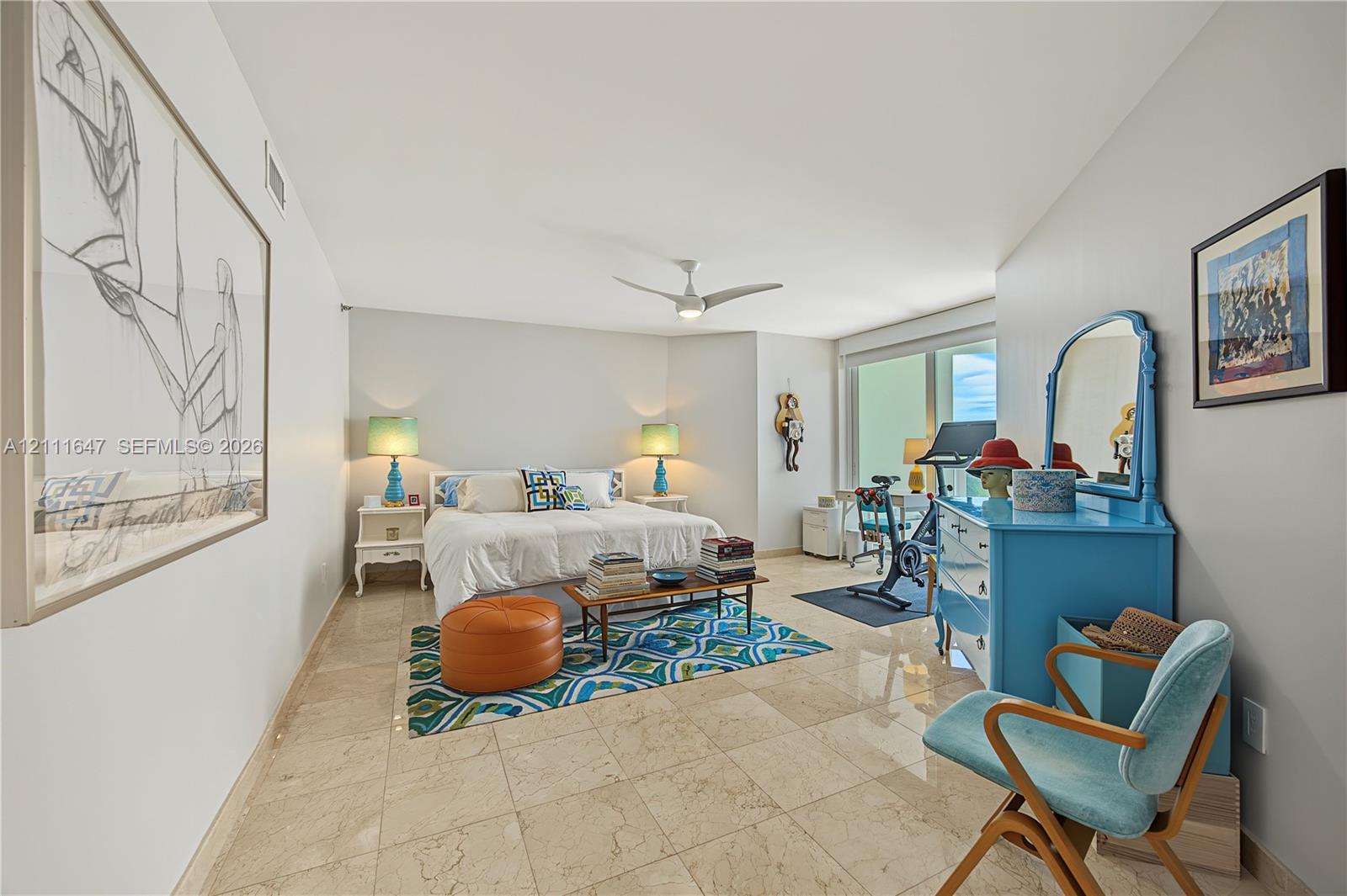 Large-format tile flooring, multi-blade ceiling fan, and floor-to-ceiling glass panel windows