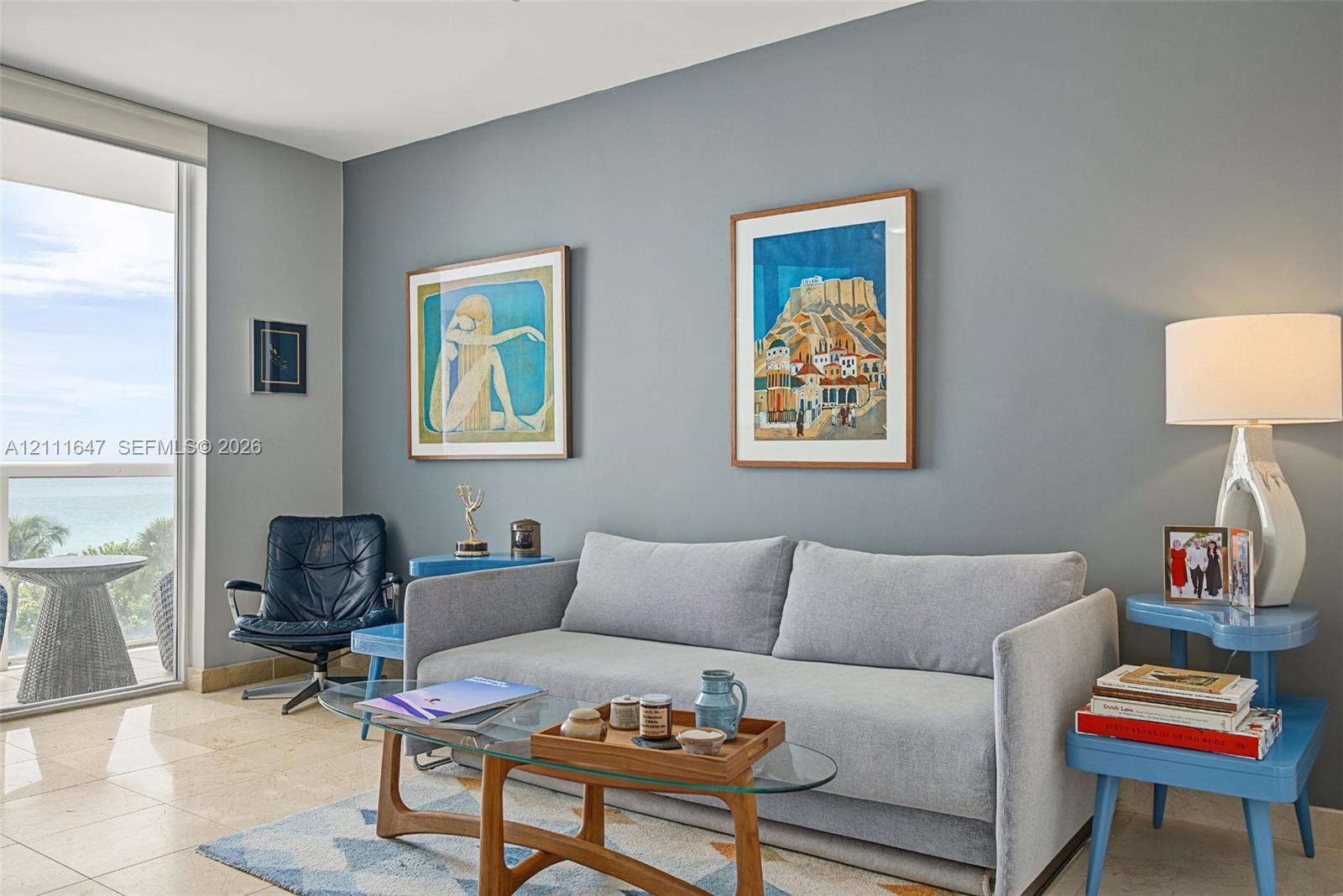 Polished stone flooring, expansive glass door, and neutral-toned wall finish