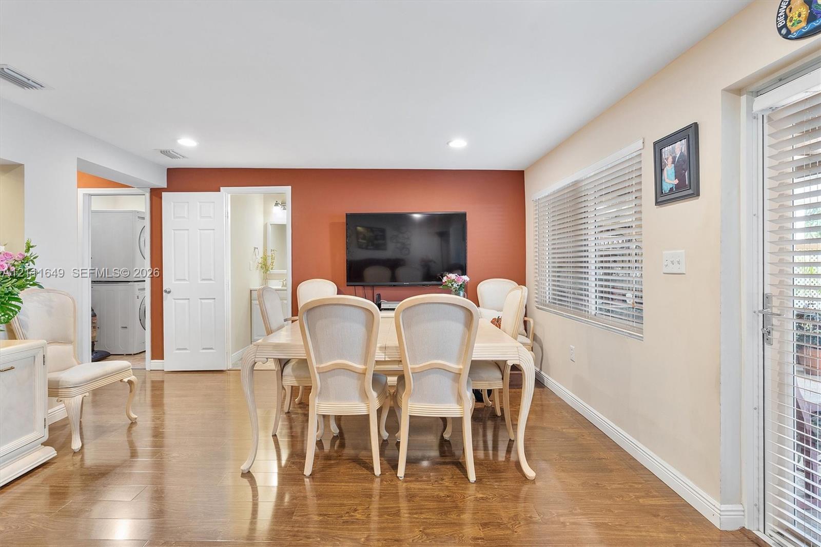 Wood-finish flooring, recessed lighting, and a glass-paneled exterior door