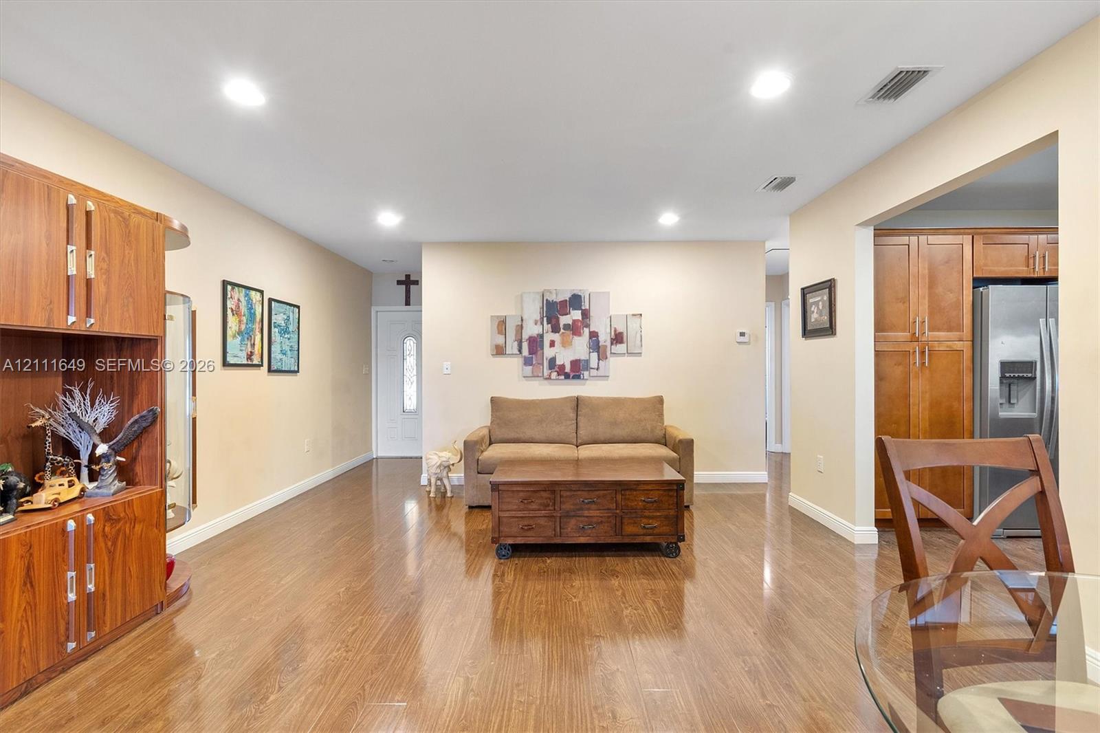 Wood-finish flooring, recessed lighting, and built-in wood cabinetry
