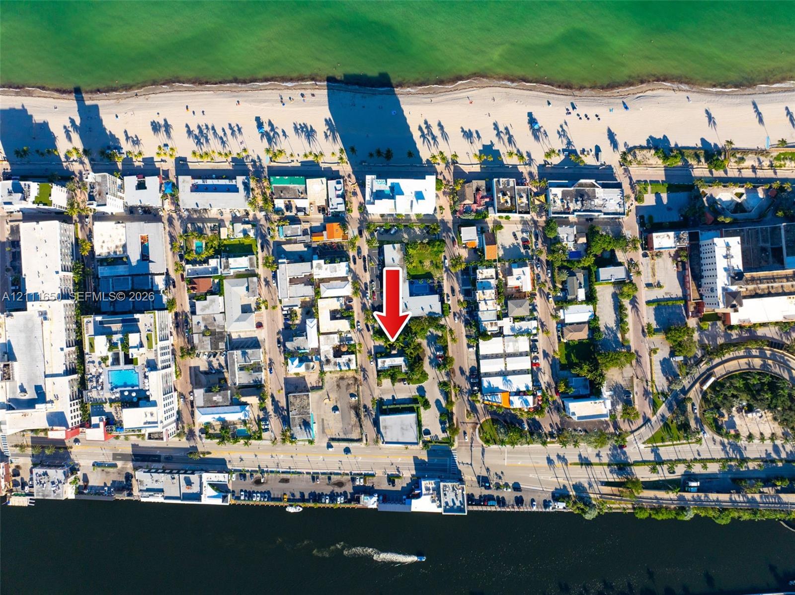 Aerial perspective of coastal property situated between oceanfront beaches and a waterway