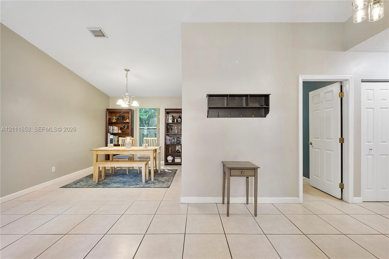 Ceramic tile flooring, vaulted ceilings, and a built-in wall-mounted coat rack