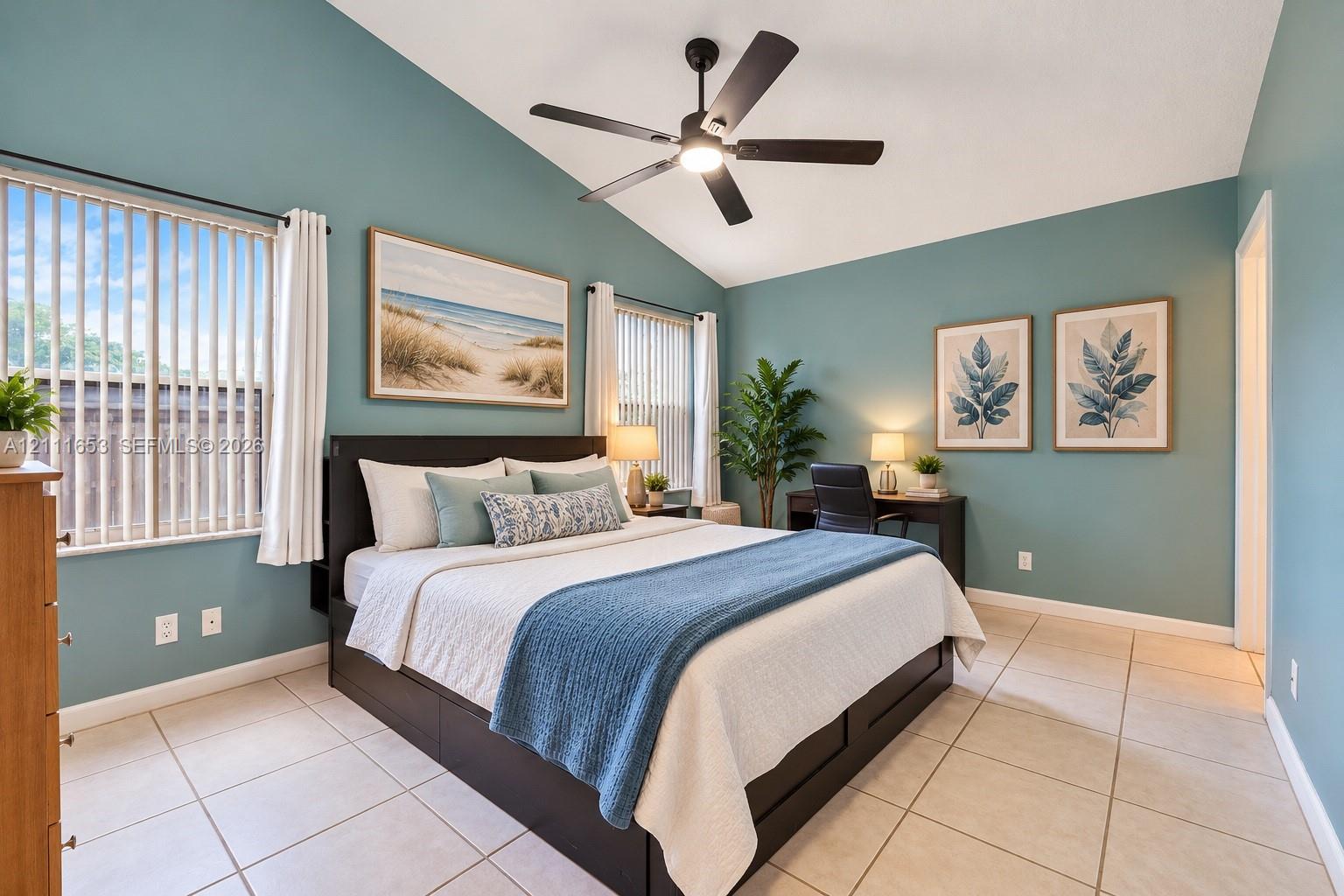 Primary Bedroom vaulted ceilings featuring a central matte black ceiling fan with an integrated light fixture, light-toned ceramic tile flooring, and multiple windows with vertical blinds