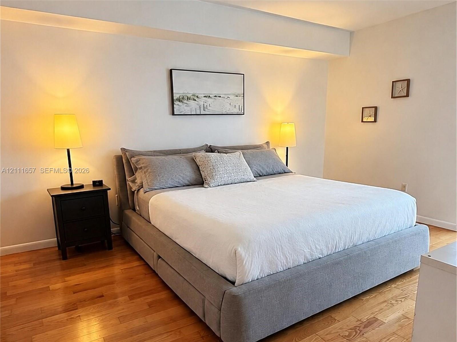 Room featuring wood-finish flooring and a recessed ceiling design